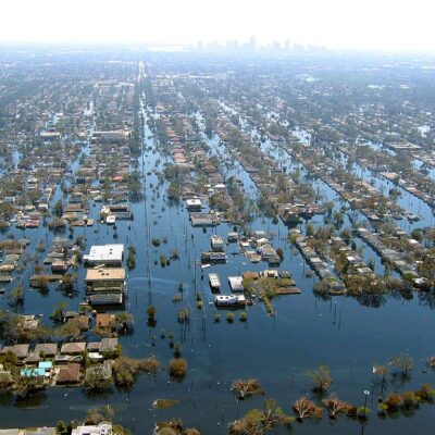 Aerial flooding of New Orleans. Home almost completely under water with only the roofs showing.