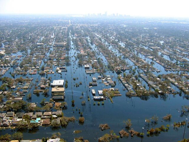 Aerial flooding of New Orleans. Home almost completely under water with only the roofs showing.