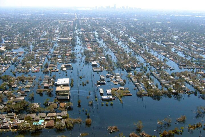 Aerial flooding of New Orleans. Home almost completely under water with only the roofs showing.