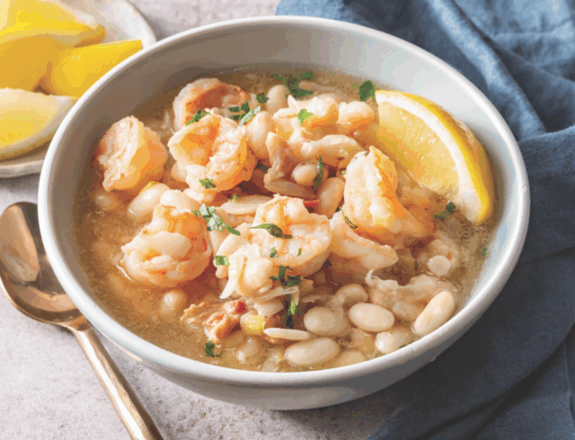 shrimp and white bean soup in a white bowl