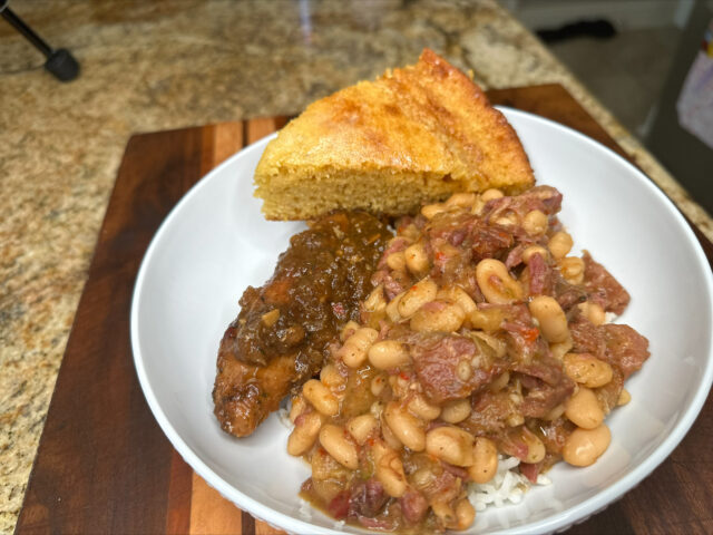 white beans with meat in a white bowl
