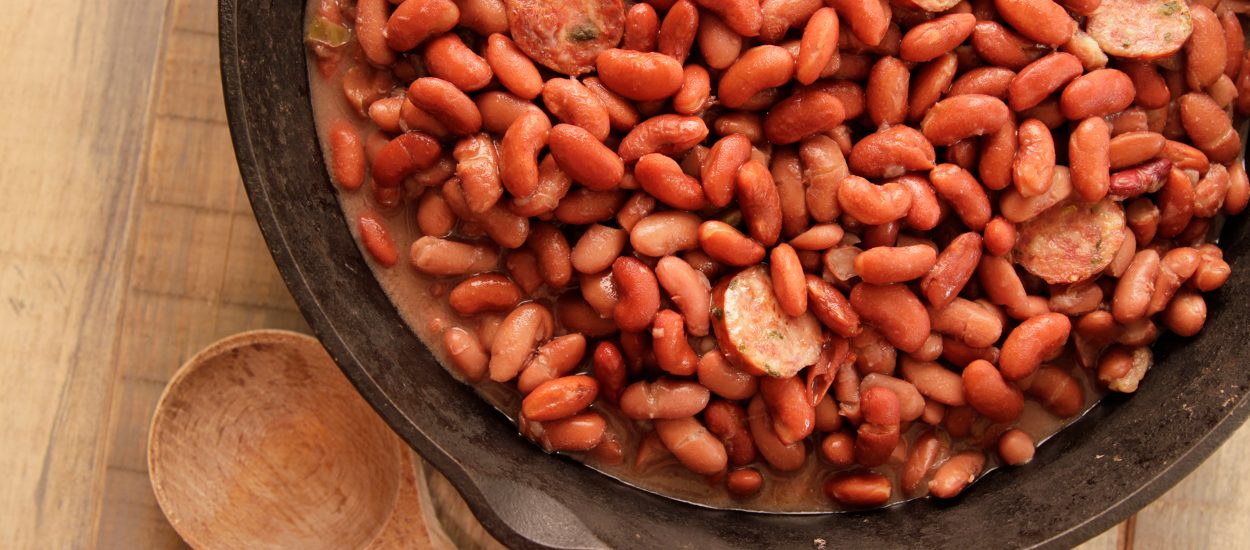 close up of red beans and sausage in a cast iron skillet